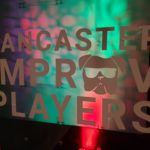 Lancaster Improv Players logo on a green and red background